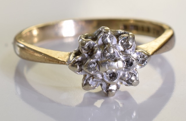 A 9ct gold diamond cluster ring. 2.0 grms - size M