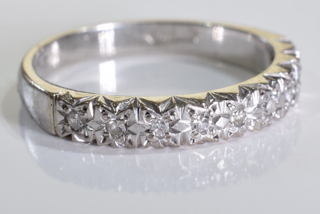 An 18ct white gold diamond ring. A half eternity ring set with brilliant cut diamonds in an 18ct - Image 2 of 4