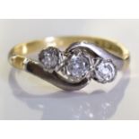 An 18ct Gold and Diamond Crossover ring, Three brilliant cut round graduated diamonds set in a