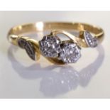 A 9ct Gold Diamond ring, Two brilliant cut diamonds set in an ornate crossover ring with side