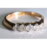 A diamond five-stone ring. The graduated circular-cut diamond line, to the tapered shoulders and