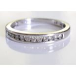 An 18ct gold diamond half-circle eternity ring. designed as a brilliant-cut diamond line, to the