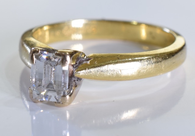 A 18ct Gold Emerald cut diamond ring. Size J. The diamond is of very good quality, clear without