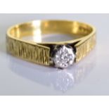 An 18ct Gold diamond solitaire ring. One brilliant cut diamond in an illusion setting, set in 18ct