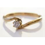 A 9ct gold diamond crossover solitaire ring. A brilliant cut diamond set in 9ct gold. 1.3grms - Size