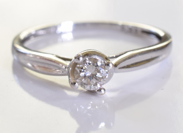 A 9ct gold white gold solitaire ring. A brilliant cut single round diamond set in 9ct white gold.