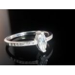 BEAUTIFUL SILVER RING (STAMPED 925) SET WITH A MARQUISE CUT SOLITAIRE STONE AND FURTHER WHITE STONES