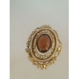 VINTAGE BROOCH SET WITH WHITE STONES AND A LARGER CENTRAL AMBER COLOURED STONES. Approx 4.5cm at