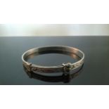 VINTAGE SILVER CHILD'S BANGLE A beautiful vintage silver child's expanding buckle bangle fully