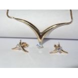 ¬V¬ necklace and earring set in 10k yellow gold. ¬V¬ shaped necklace with a round cut 0.35ct diamond