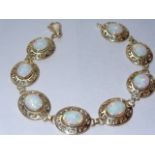 Versace style bracelet set in 14k gold and adorned with 8 genuine opals.Measures approx 7.5 inch.