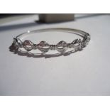 Dainty white gold and diamond bangle with a delicate loop design. 17 diamonds Vs,F-G, approx. 0.30