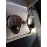 Unique cufflinks in 14k brushed white gold. Each cufflink boast 3 diamonds and a black tahitian