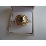 Wide antique 18k gold ring with an oval emerald in the center and surrounding diamonds.signed '