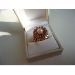 Vintage flower ring with a large freshwater pearl center and surrounder by 13 round cut