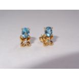 18k Stud Earrings with a oval shape Blue Topaz and Diamond.Dainty 18k gold and diamond stud earrings