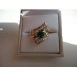 Vintage and unique twist ring with a large emerald center surrounder by 14 round cut diamonds. Set