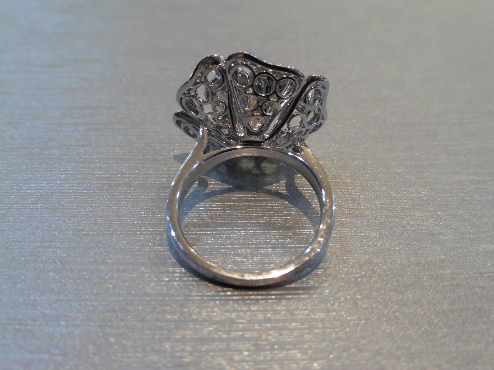 Brand new 18ct white gold high set fancy dress ring. Set in a flower design with small brilliant cut - Image 2 of 4