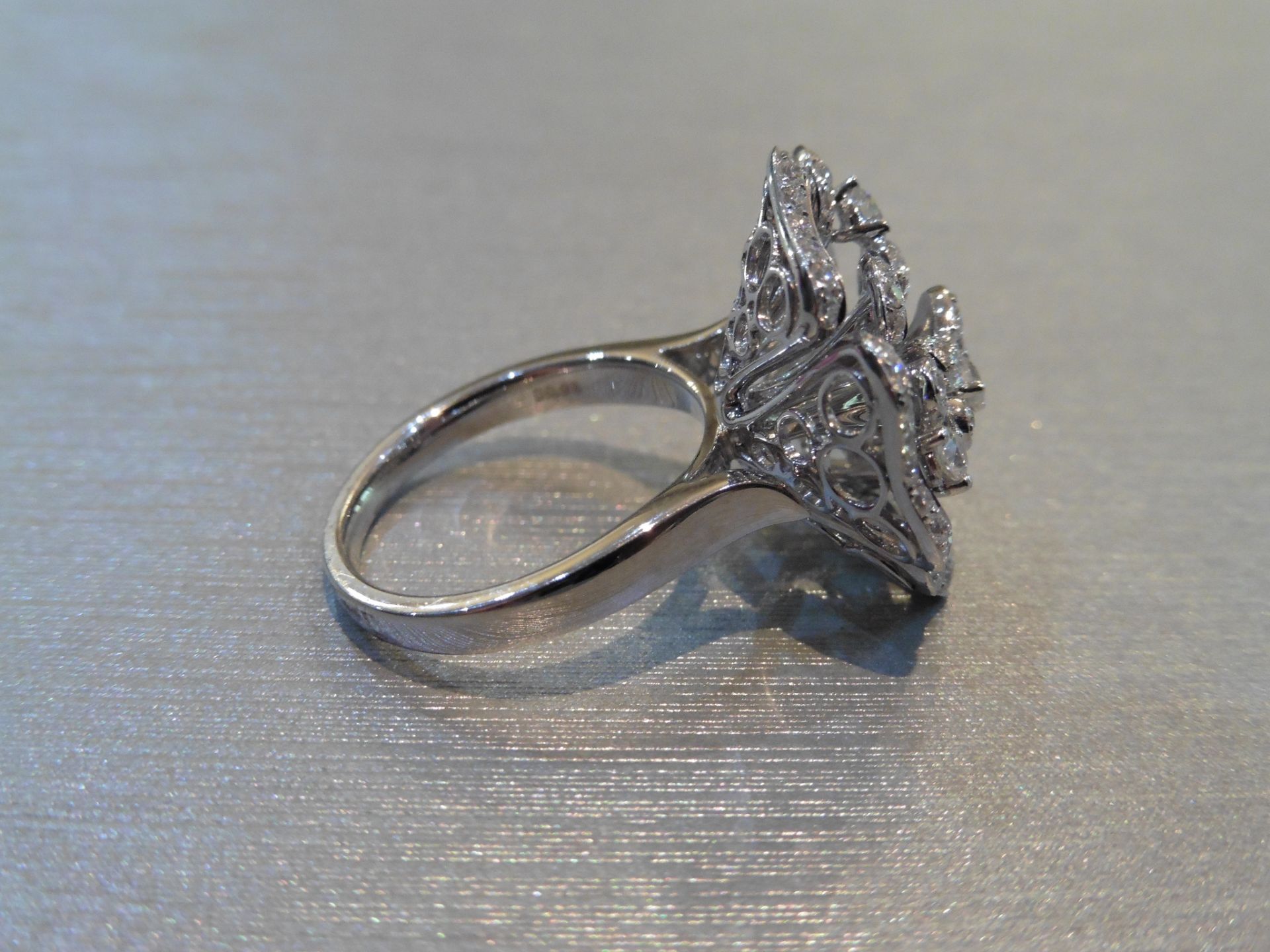 Brand new 18ct white gold high set fancy dress ring. Set in a flower design with small brilliant cut - Image 3 of 4