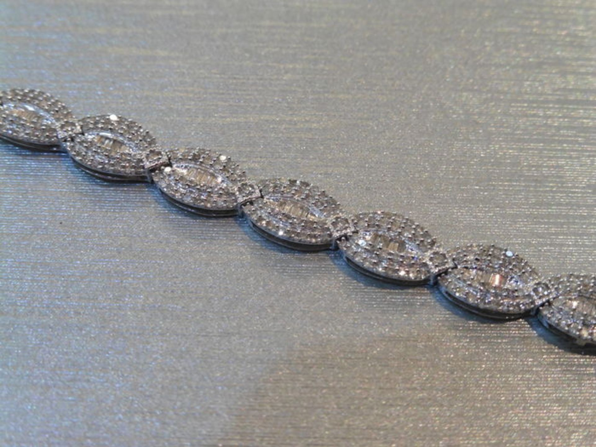 Brand new 10ct white gold fancy diamond bracelet set with oval sections of small baguette cut - Image 3 of 4