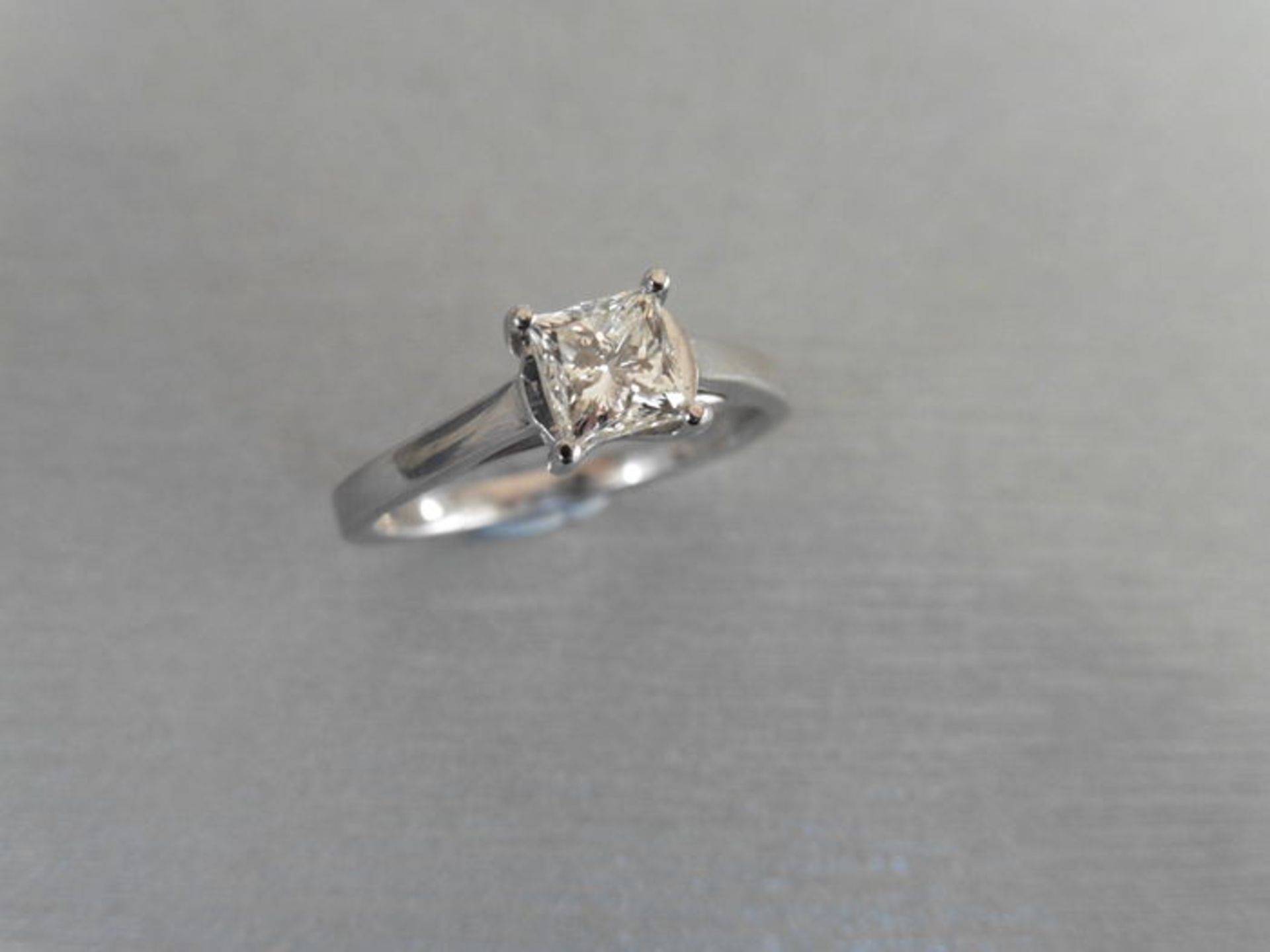 Brand new platinum diamond solitaire ring set with a 0.75ct princess cut diamond, I colour and Vs1