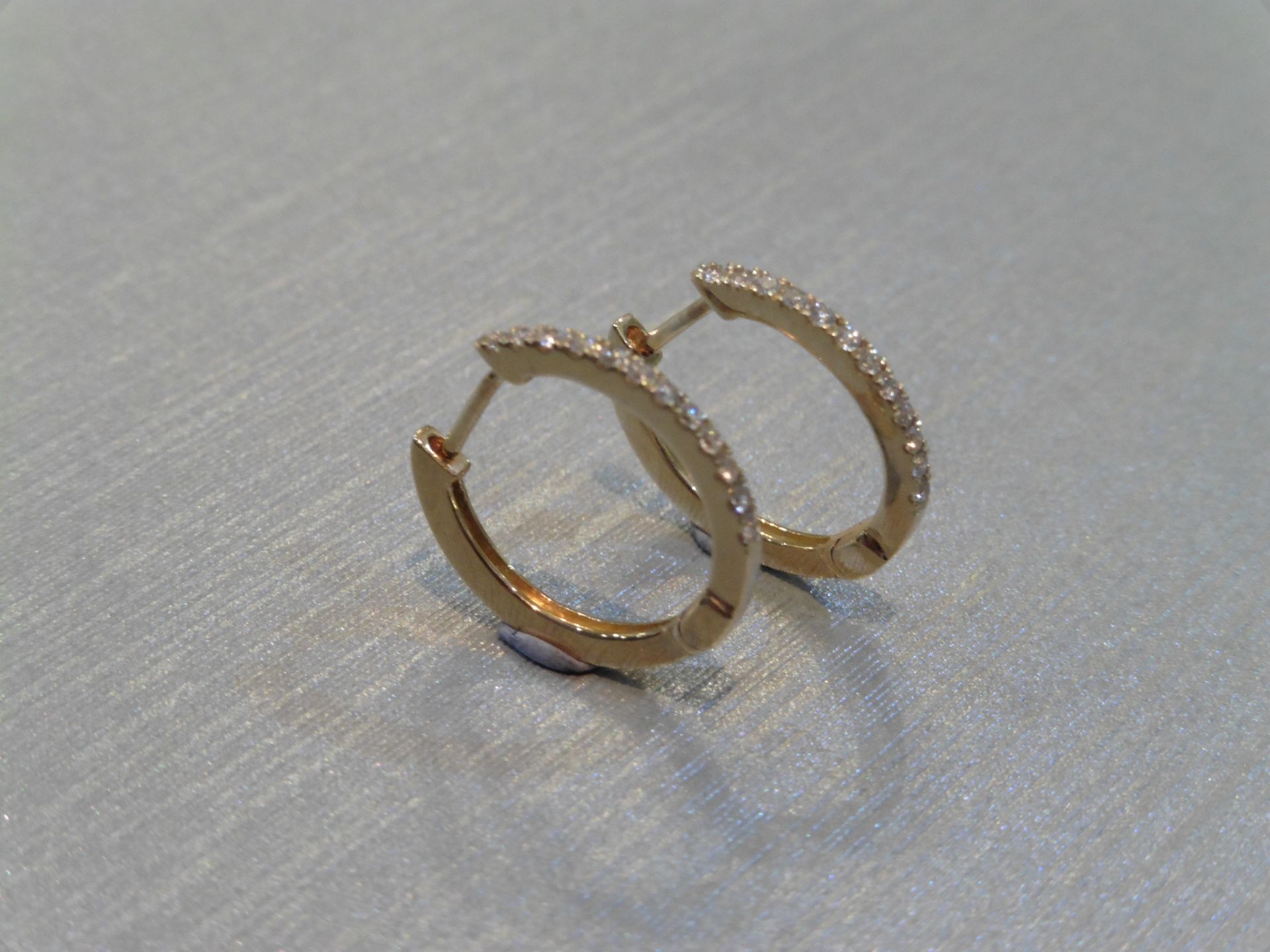 Brand new 18ct yellow gold _ hoop style diamond earrings. Each set with tiny brilliant cut diamonds,