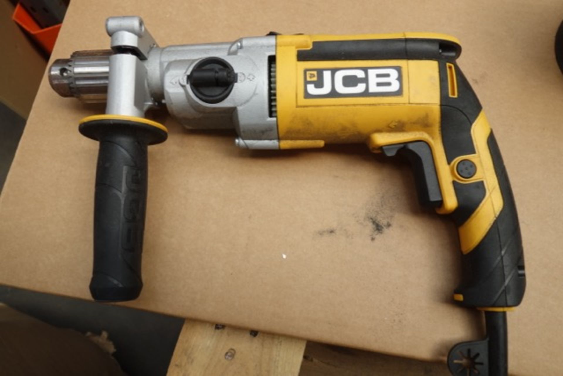 (D13) JCB 900w Hammer Drill. Note: Ex-display item, power cord has been cut.