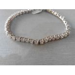 Pre-owned 14ct white gold diamond tennis style bracelet set with brilliant cut diamonds, weighing