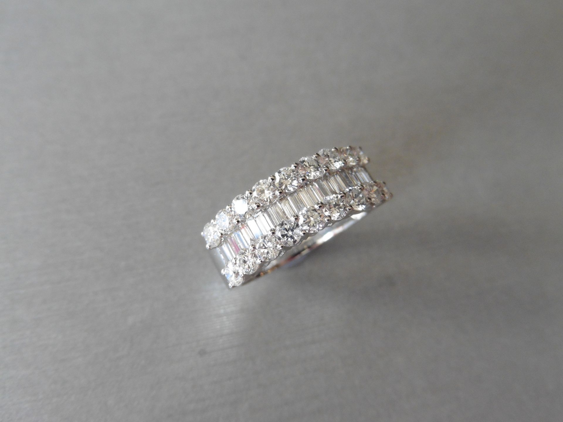 18ct white gold diamond band dress ring. Set with 3 rows of diamonds, 2 rows of brilliant cut