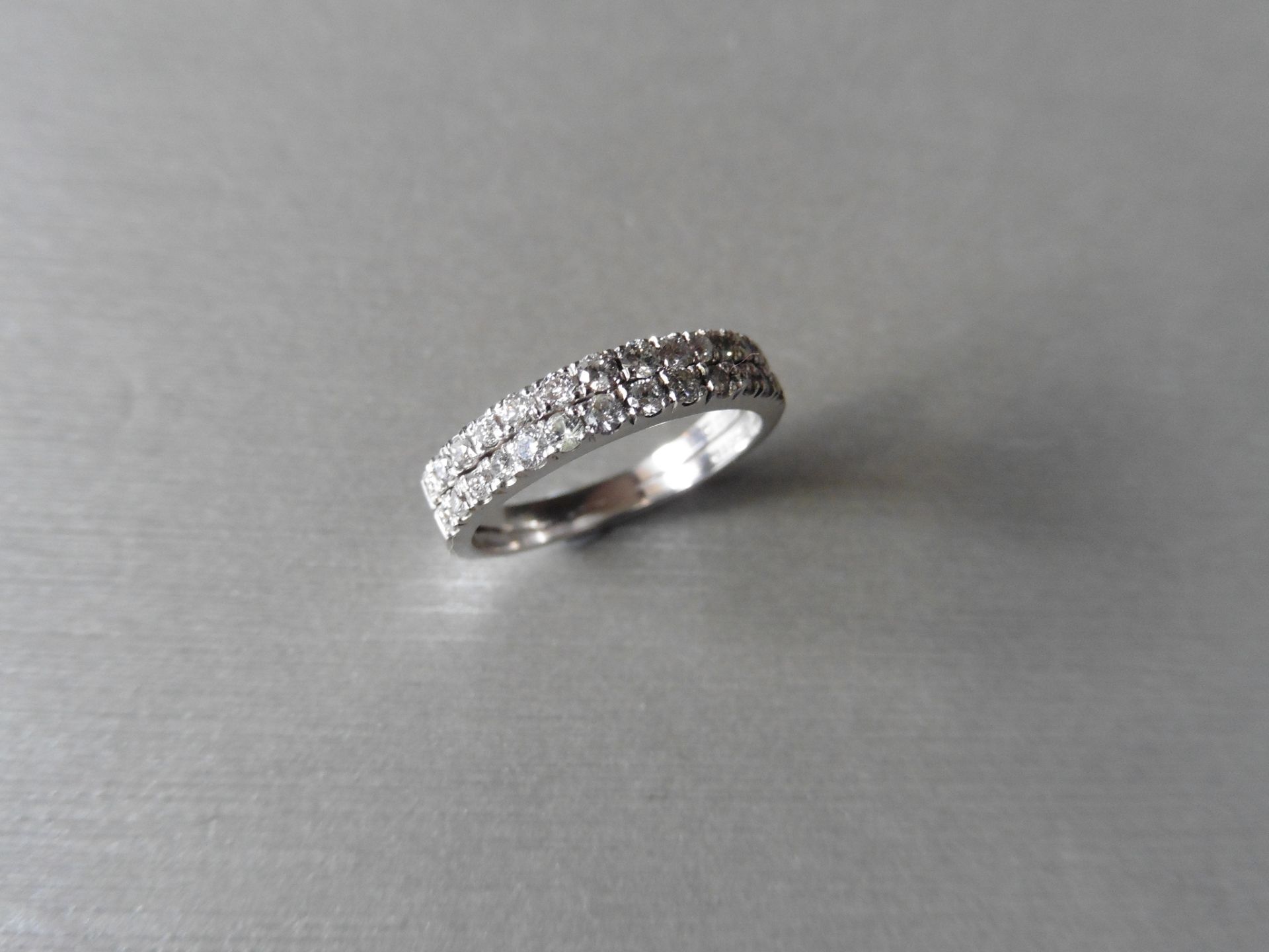 Diamond band ring. Set with 2 rows of small brilliant cut diamonds, H colour si3 clarity, weighing a