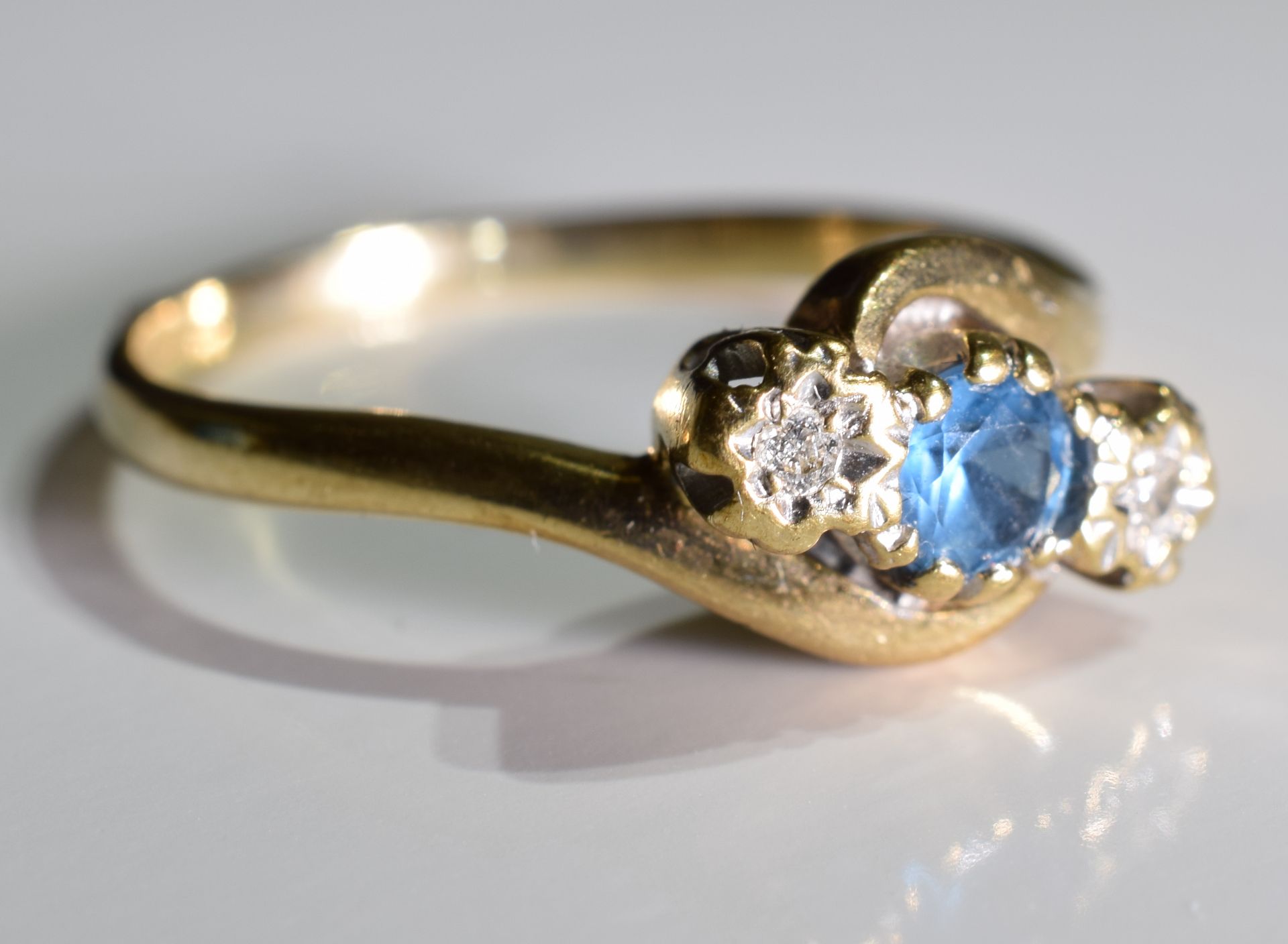 A 9ct Gold Sapphire and Diamond trilogy twist ring, - Image 2 of 3