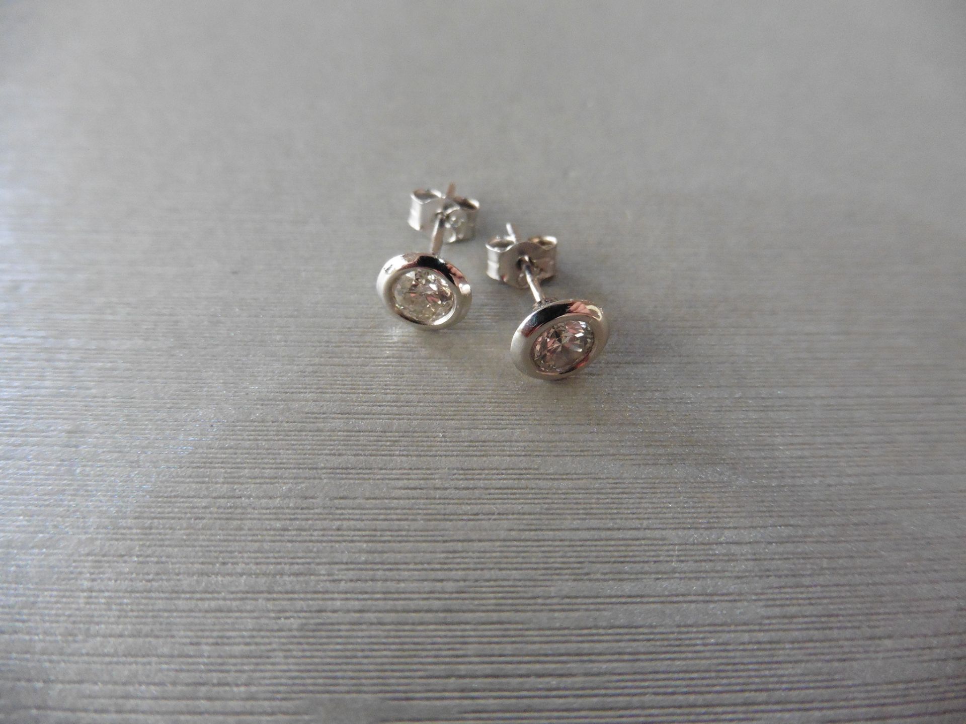 Solitaire diamond stud earrings each set with a brilliant cut diamond, H colour, si2 clarity,