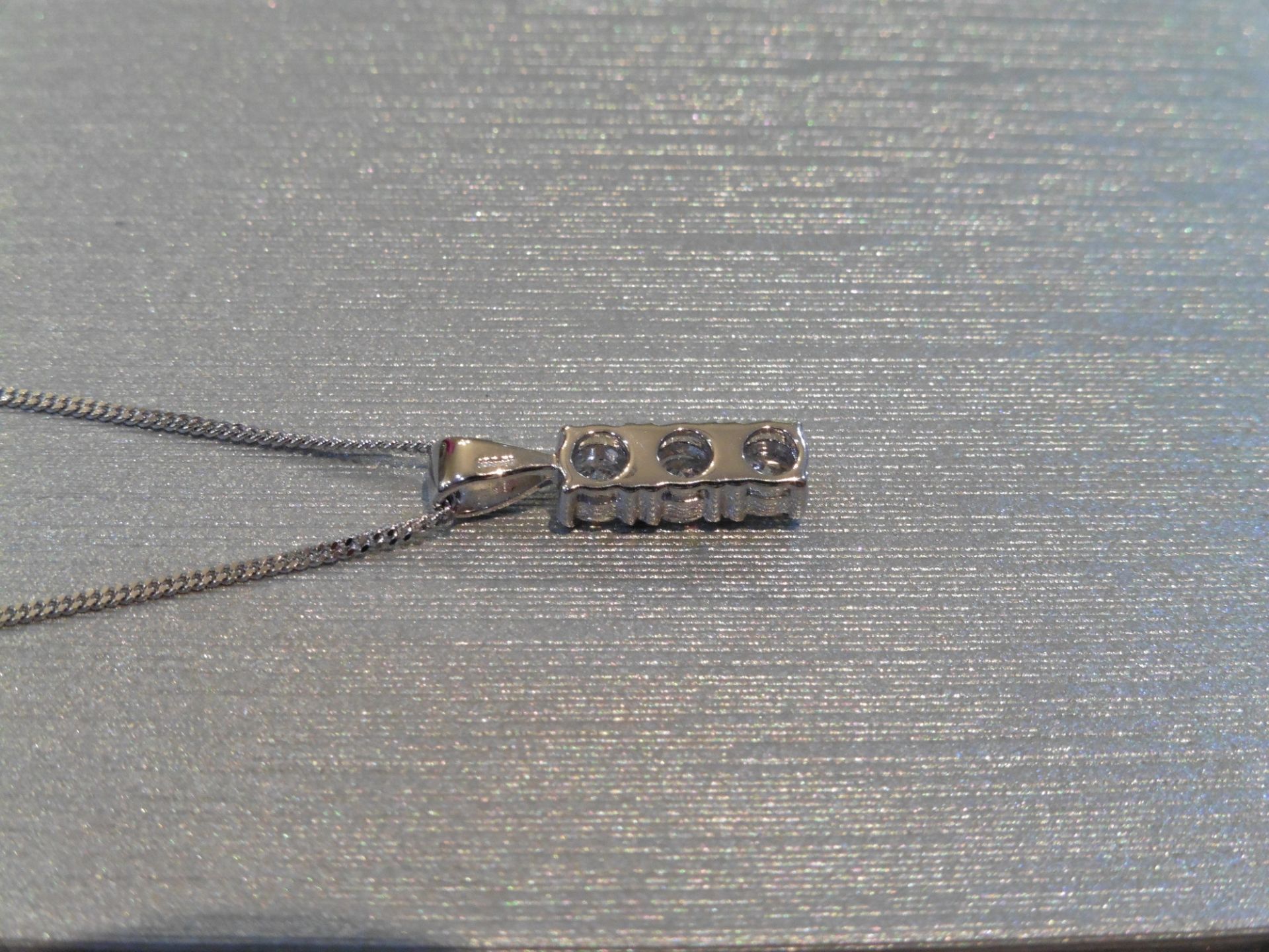 Trilogy pendant set with 3 small brilliant cut diamonds of H/I colour weighing a total of 0.60ct. - Image 3 of 3