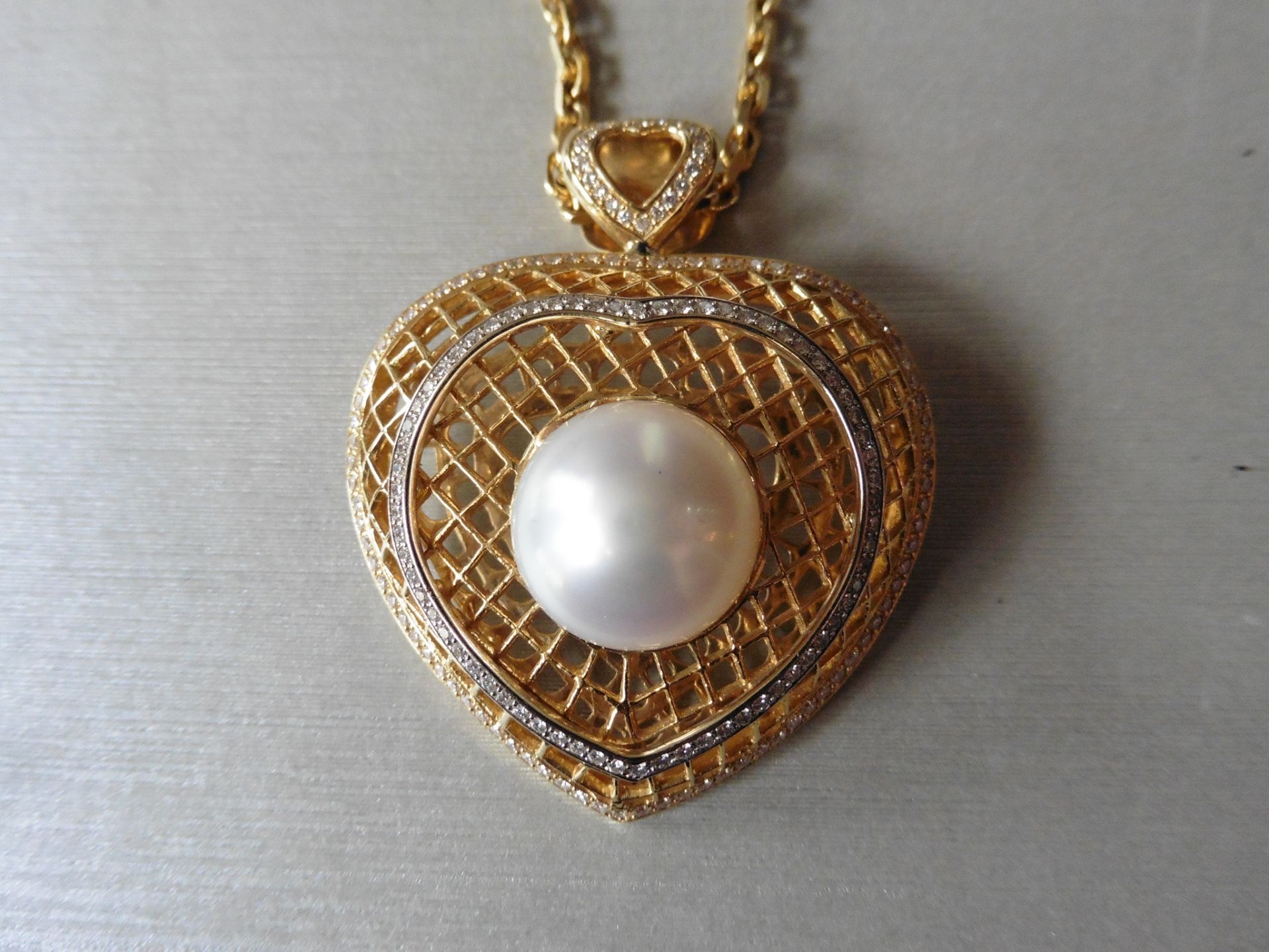 18ct yellow gold pearl and diamond heart shaped pendant. Centred white pearl measuring approximately