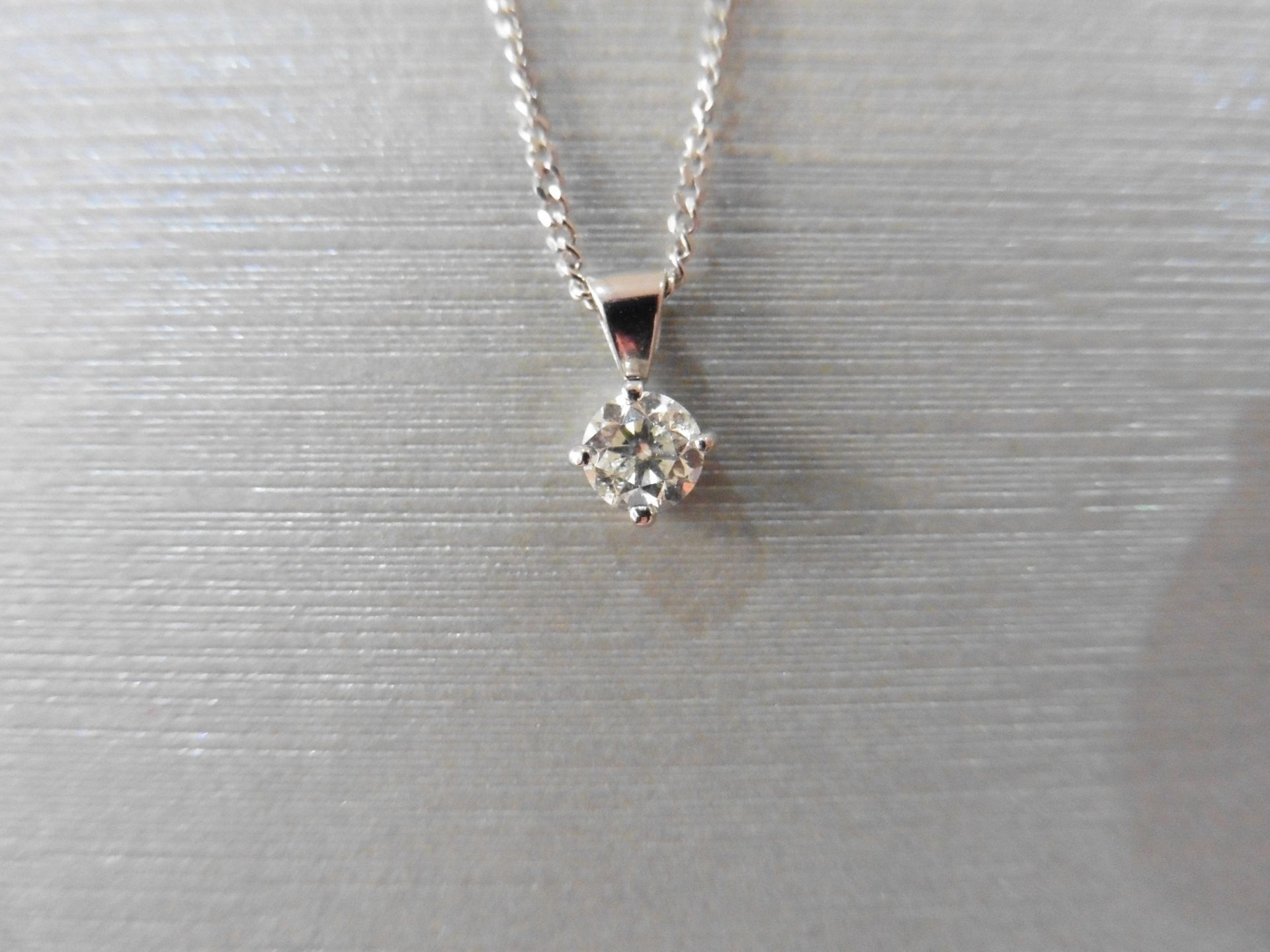 diamond solitaire pendant set with a 0.30ct brilliant cut diamond, H/I colour, si3 clarity. Four