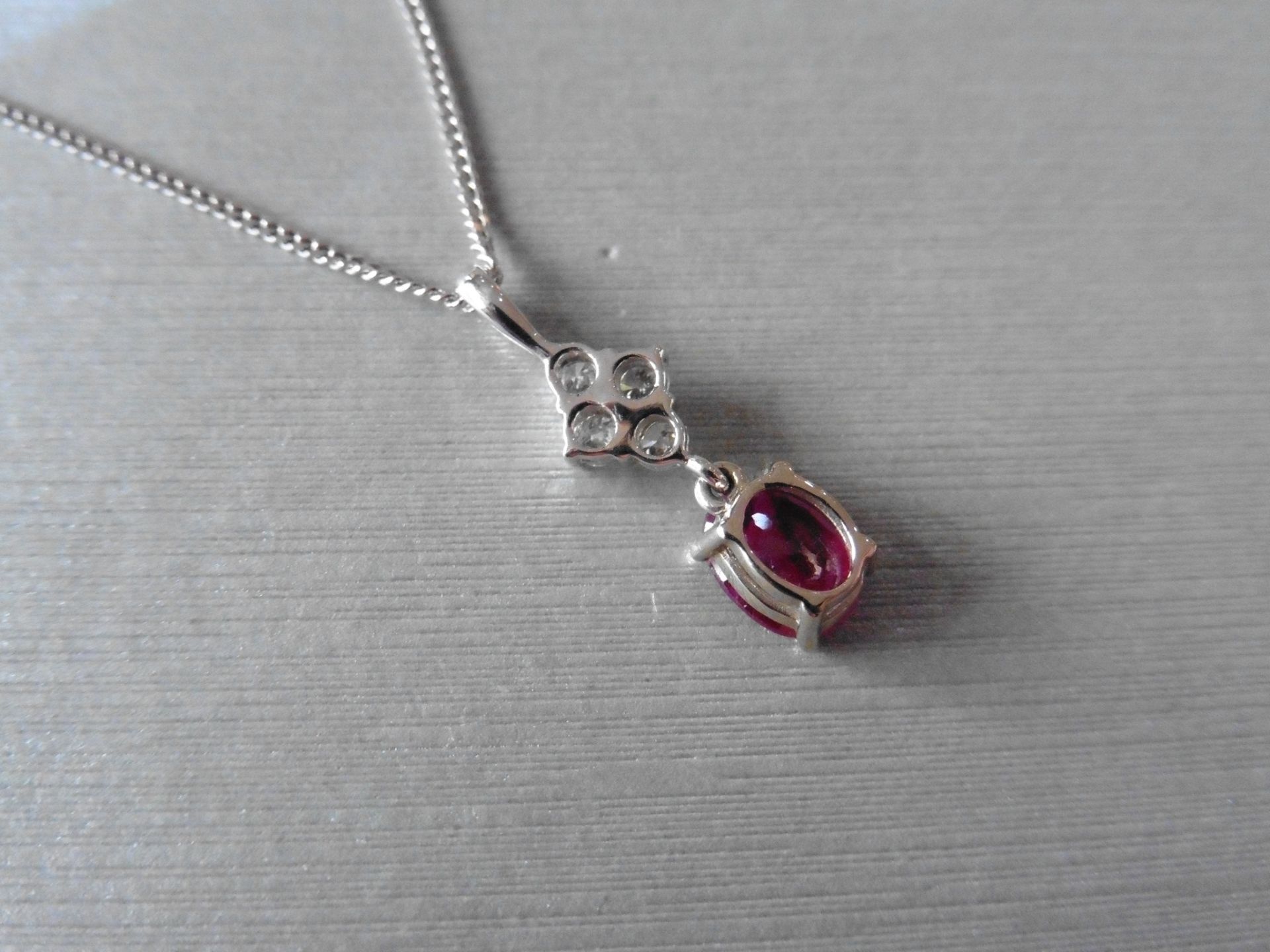 Ruby and diamond pendant set with an oval cut ruby weighing 1.50ct. Set on top are four small - Image 3 of 3