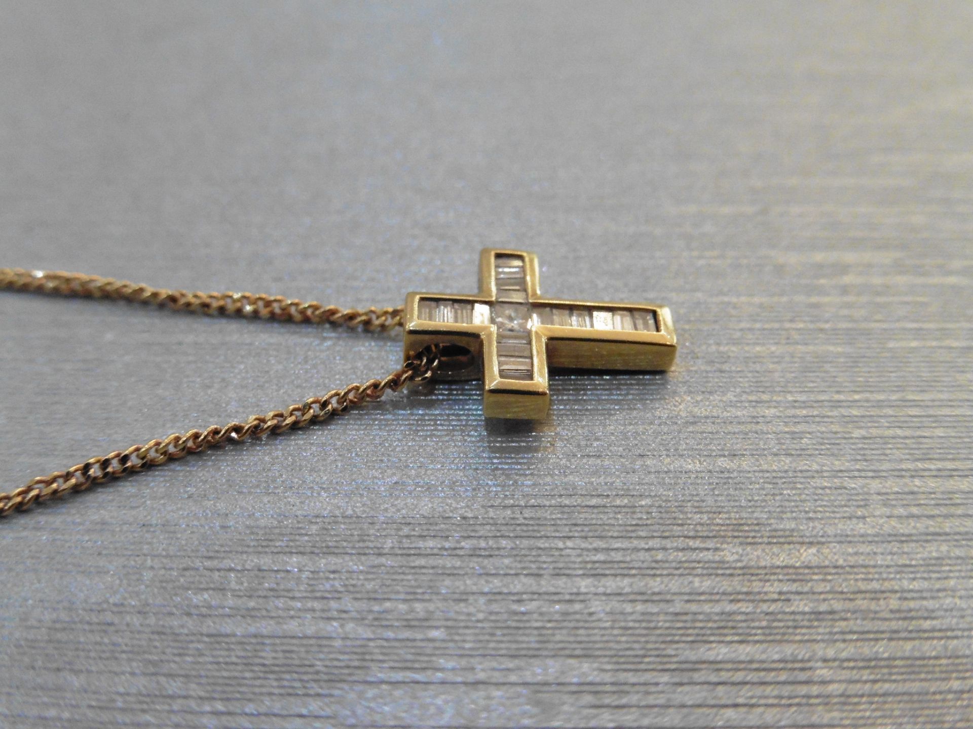 Diamond cross pendant set with 1 small princess cut diamond in the centre and surrounded by baguette - Image 2 of 3