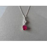 Ruby and diamond pendant set with an oval cut ruby weighing 1.50ct. Set on top are four small