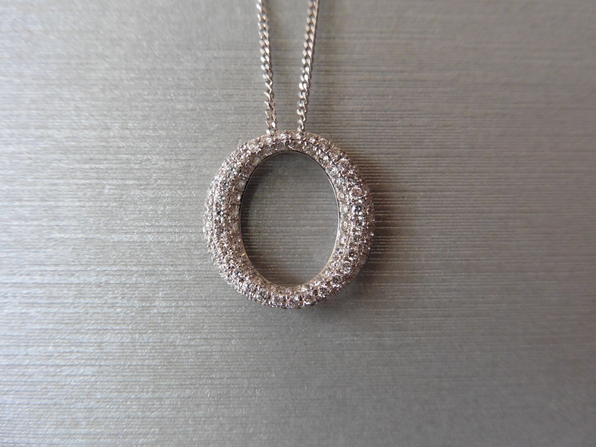 18ct white gold diamond set pendant in an 'o' design. Set with tiny brilliant cut diamonds