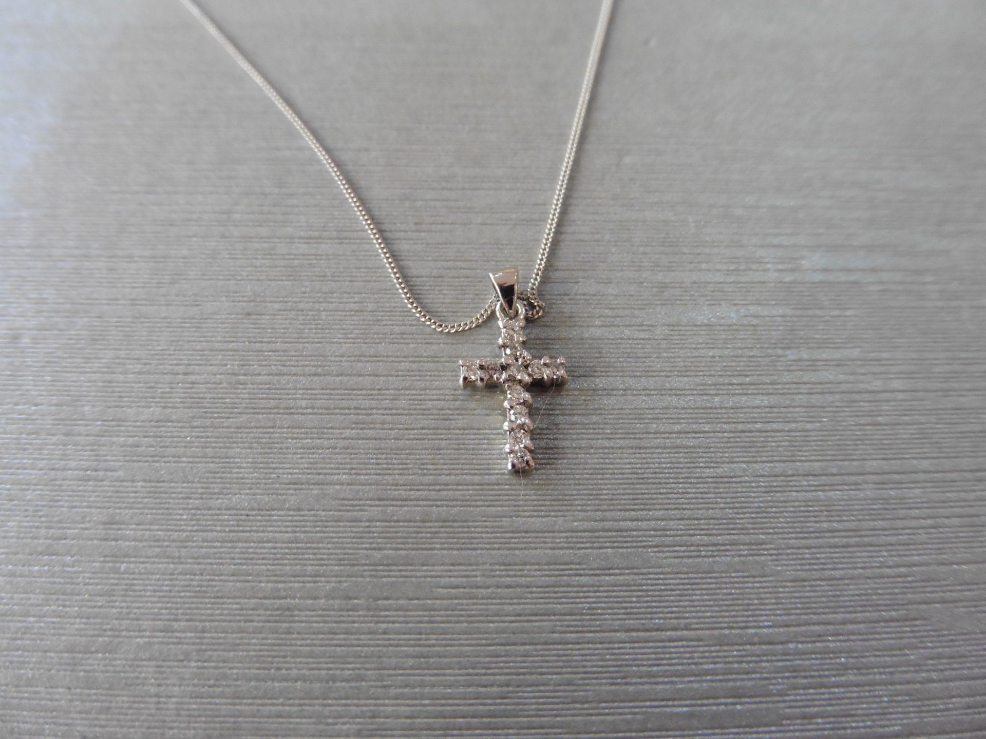 Diamond cross pendant set with small brilliant cut diamonds, total weight 0.10ct. H/I colour and si3
