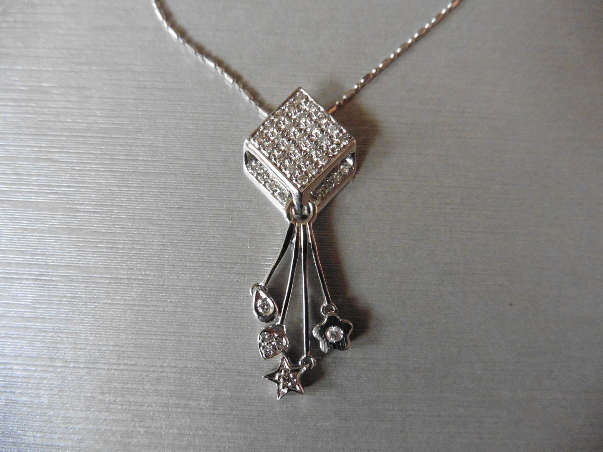 18ct white gold fancy drop pendant. Diamond shaped design at the top which is micro set with tiny