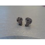 Pear shaped diamond earrings. Each is illusion set with small brilliant cut diamonds, weighing 0.