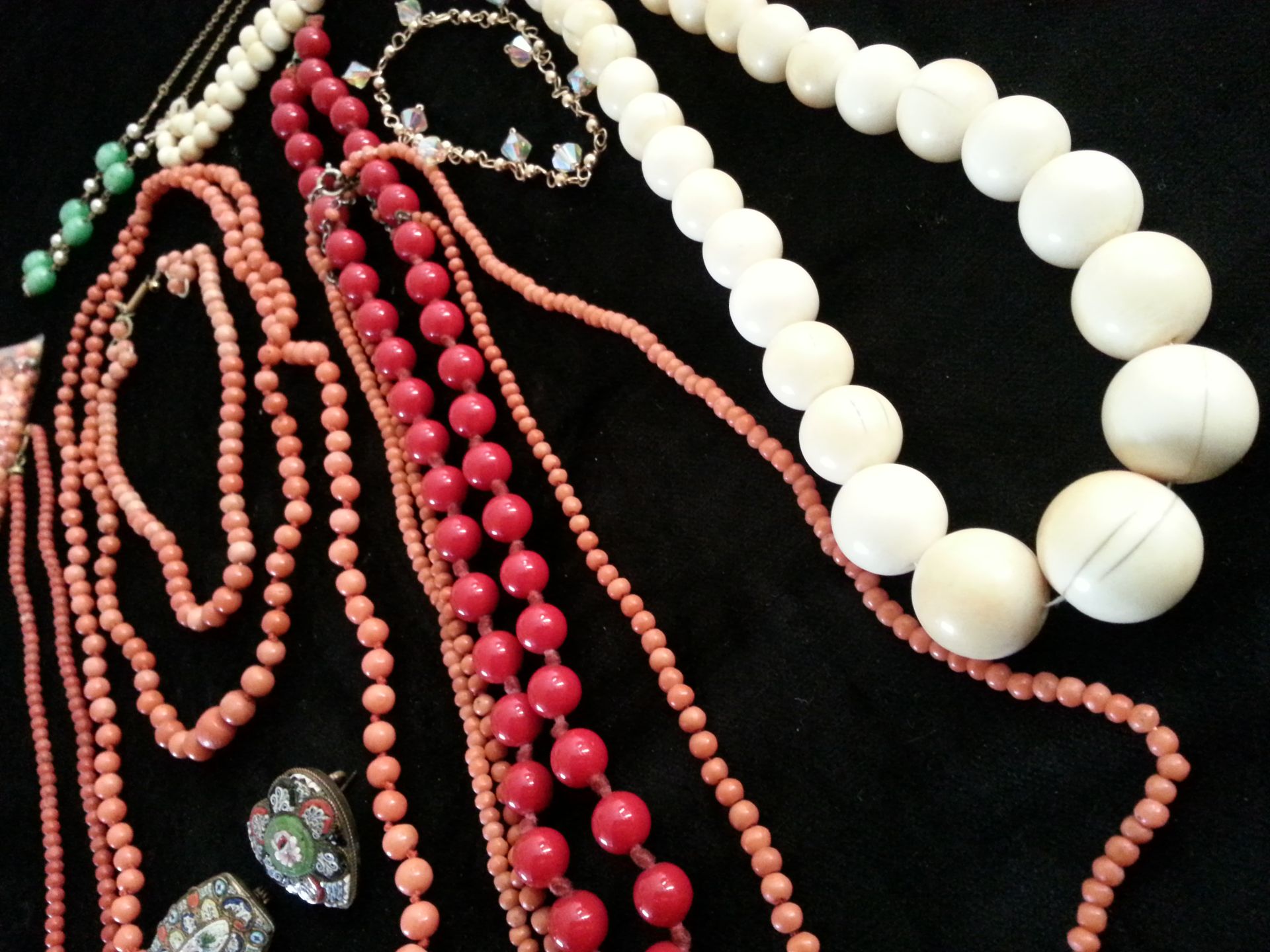A collection of bead necklaces to include Coral and others.