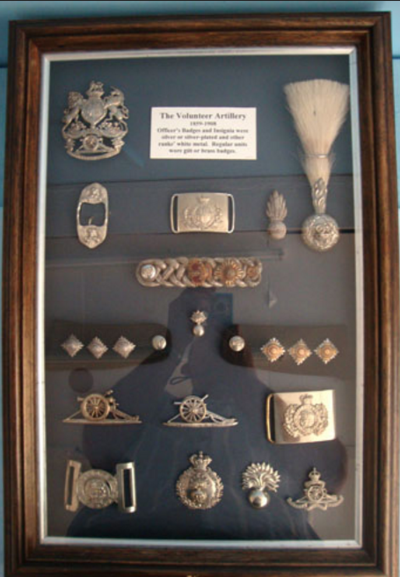 A Large Frame Of 'Volunteer Artillery' Badges And Insignia 1859-1908.