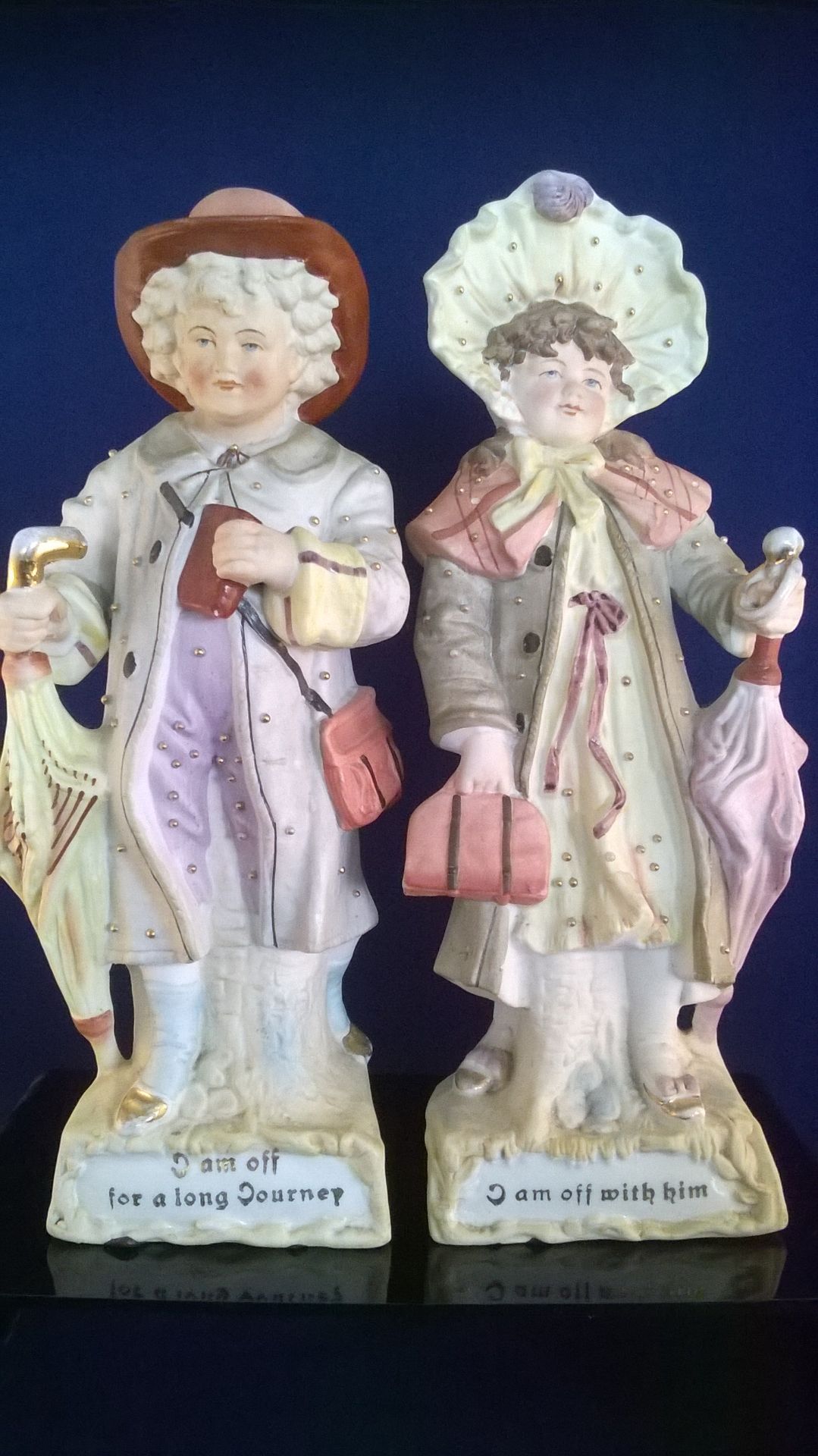 PAIR OF DELILGHTFUL LARGE BISQUE CHINA FAIRINGS "I AM OFF FOR A LONG JOURNEY" and "I AM OFF WITH