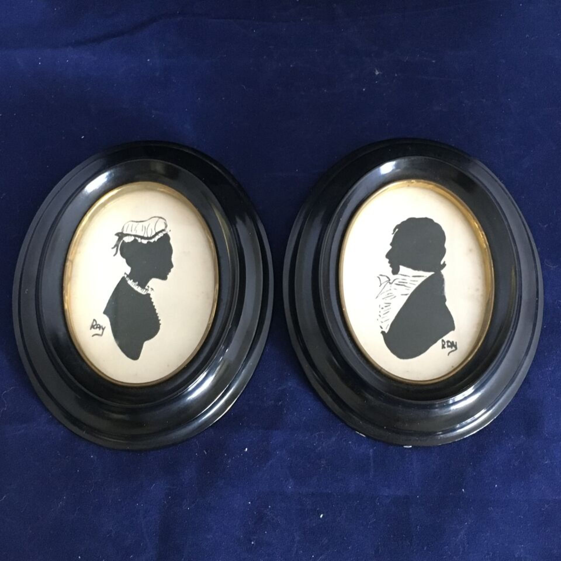 TWO SILHOUETTE TYPE PORTRAIT MINIATURES IN OVAL BAKELITE FRAMES. EACH MEASURES 11CM X 14CM. FREE