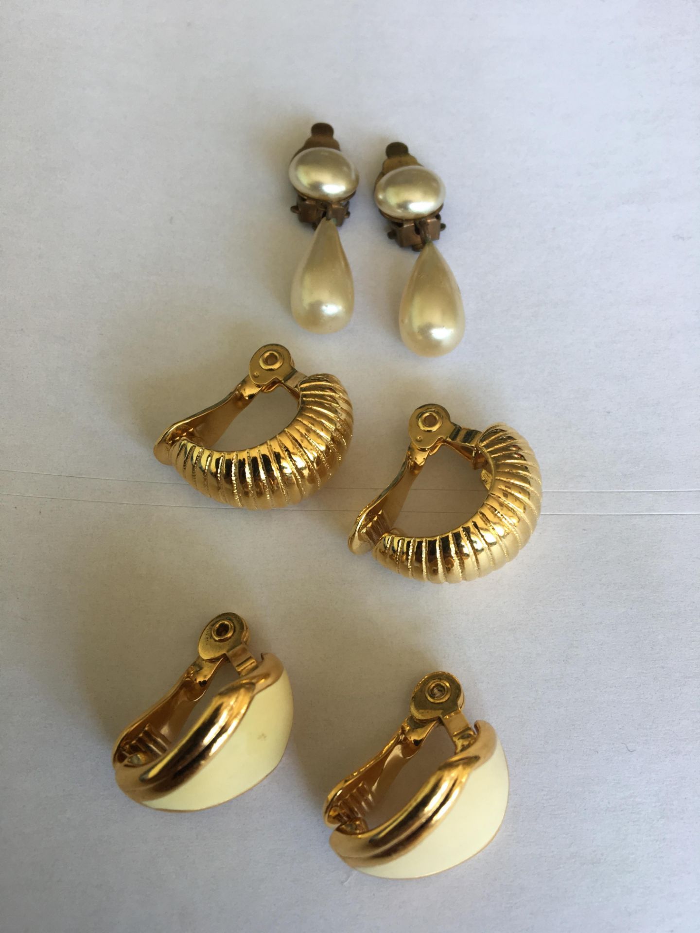 GOOD SELECTION OF VINTAGE CLIP ON EARRINGS. ONE FAUX PEARL DROP AND THE OTHER TWO SIGNED MONET. FREE