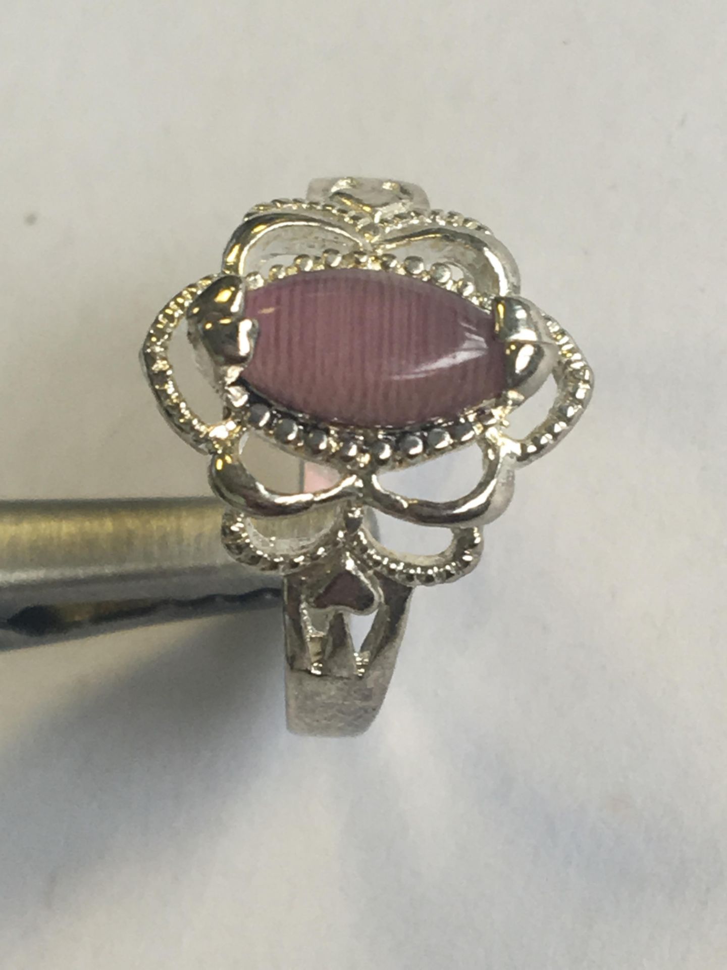 A SILVER (STAMPED 925) RING WITH PURPLE STONE. SIZE K. FREE UK DELIVERY.