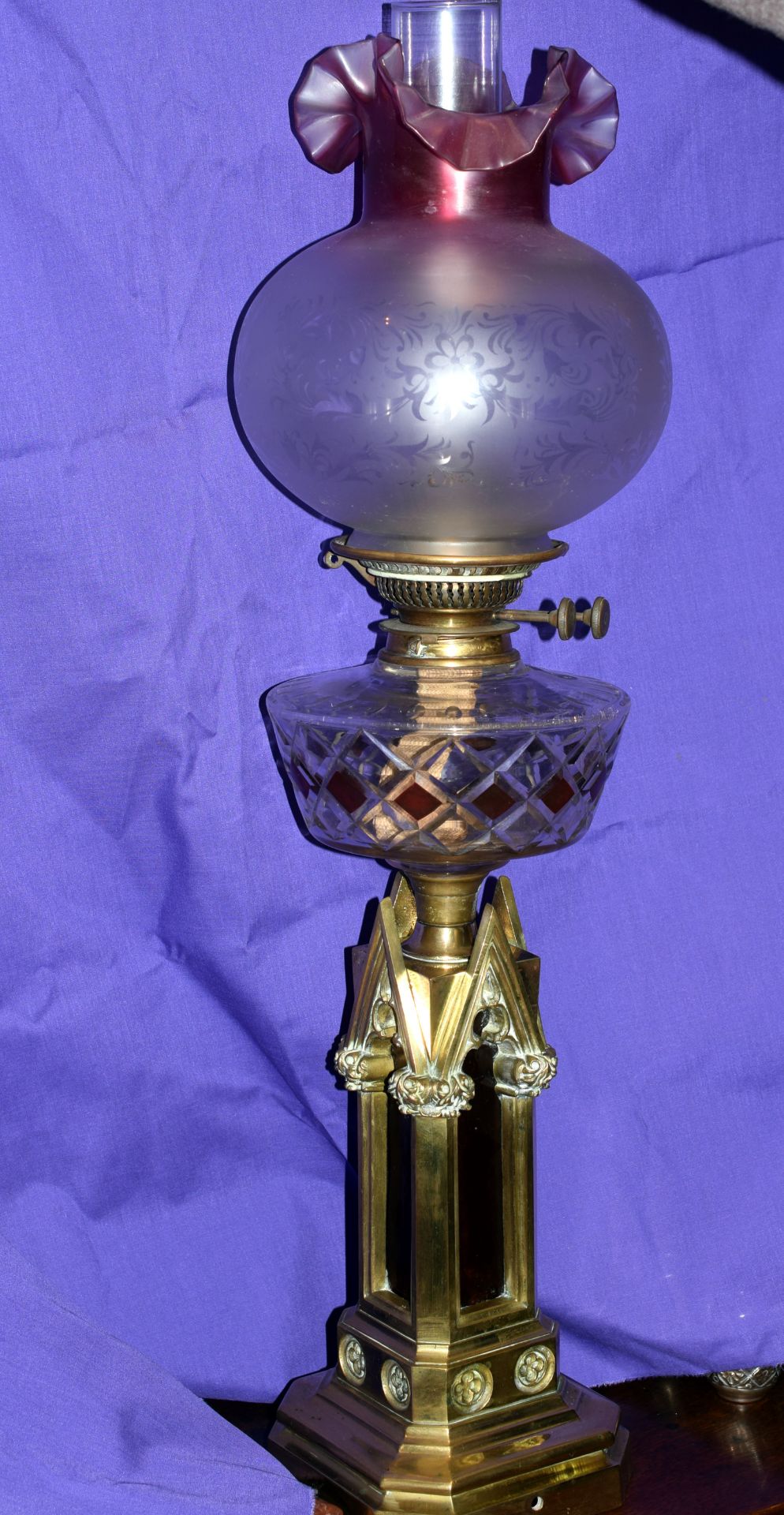 Late 19th to Early 20th Century Cathedral Style Brass Based Oil Lamp With Cranberry Glass