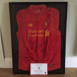 Signed Liverpool FC shirt in frame.